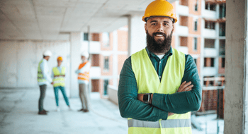 construction workers discussing project plans at a busy worksite